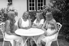 Black and white portrait of mother and daughters at a table CFP1058-1M