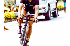 Cyclist riding along Lake Kivu during Ironman Rwanda 70.3