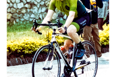 Cyclist riding along Lake Kivu during Ironman Rwanda 70.3