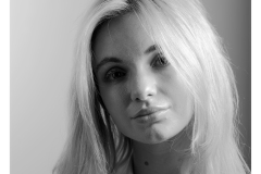 Side-lit studio portrait of Vicki Alexia in black and white